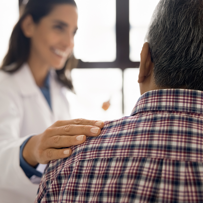 Closeup, nurse touch shoulder of senior male patient during talk